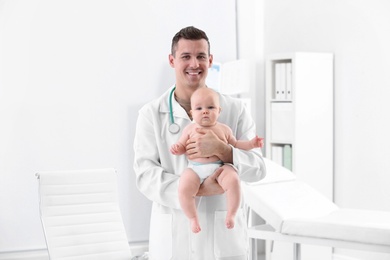 Photo of Children's doctor with cute baby in hospital