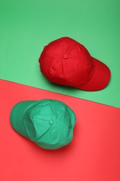 Photo of Baseball caps on color background, flat lay Mock up for design