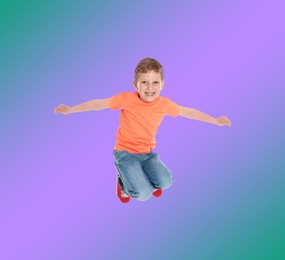 Image of Happy boy jumping on color gradient background