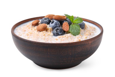 Photo of Tasty wheat porridge with milk, blueberries and almonds in bowl isolated on white