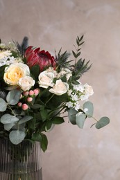 Photo of Beautiful bouquet with roses on beige background, closeup