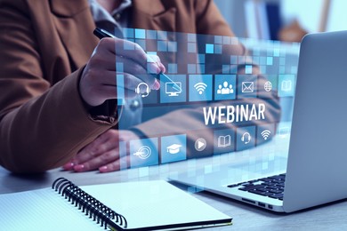 Webinar. Woman using virtual screen over laptop at table, closeup