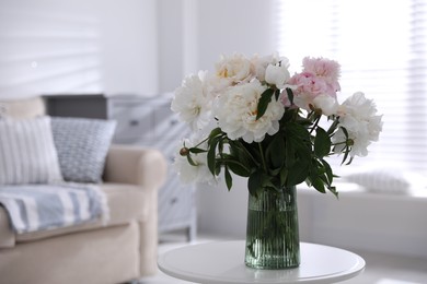 Photo of Bouquet of beautiful peony flowers on table indoors. Space for text