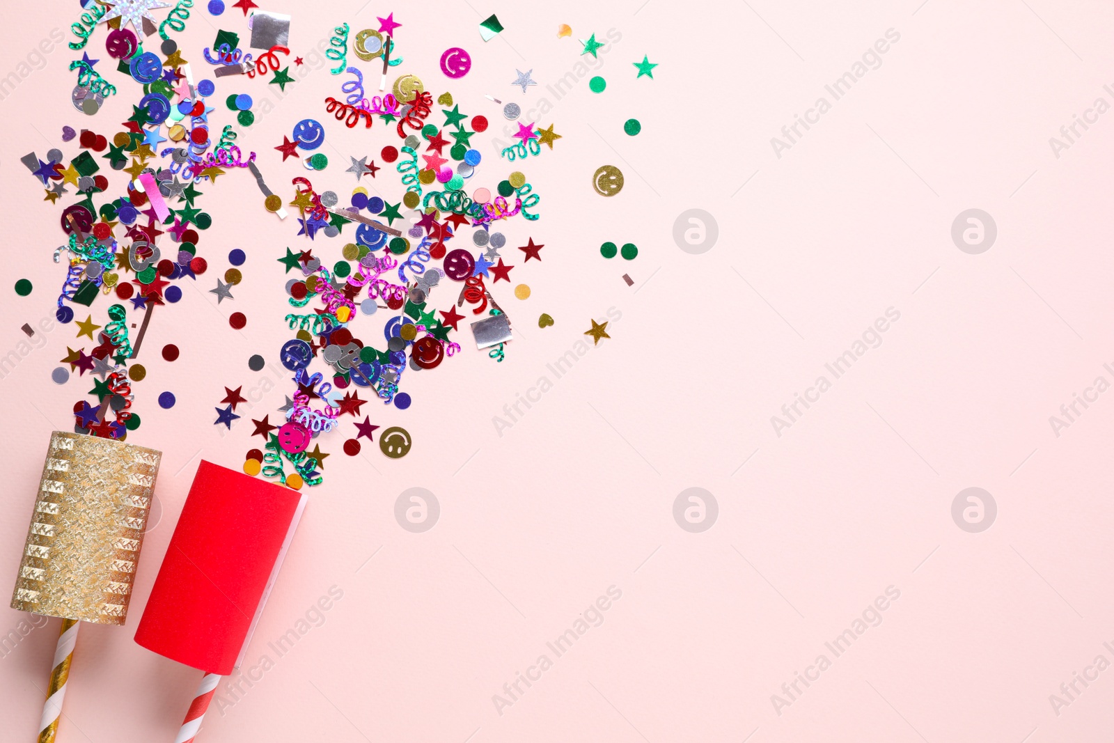 Photo of Flat lay composition of colorful confetti and party crackers on white background, space for text