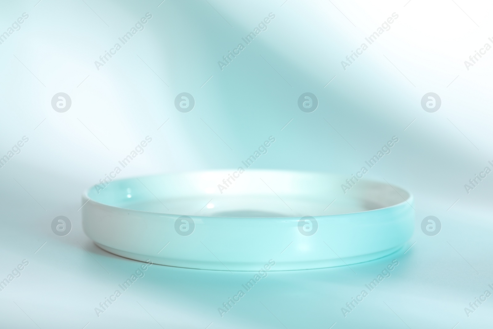 Photo of Presentation of product. Podium on light blue background, space for text