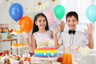 Happy children at birthday party in decorated room