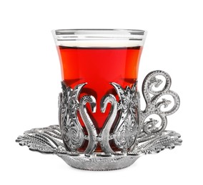 Photo of Glass of traditional Turkish tea in vintage holder isolated on white
