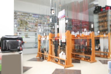 Photo of Blurred view of sports shop with fishing equipment