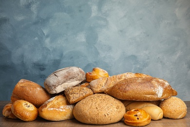 Fresh breads and pastries on wooden table