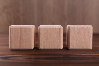 Photo of Cubes with abbreviation ISO on wooden table, closeup