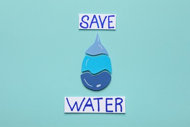 Photo of Words Save Water and drop on turquoise background, flat lay