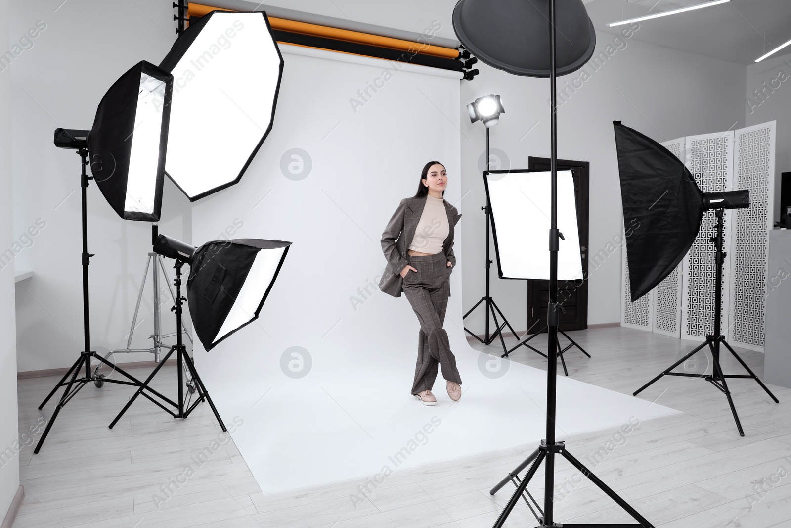 Photo of Beautiful young model posing in modern studio. Professional photo session