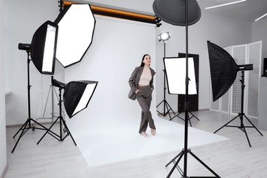 Photo of Beautiful young model posing in modern studio. Professional photo session