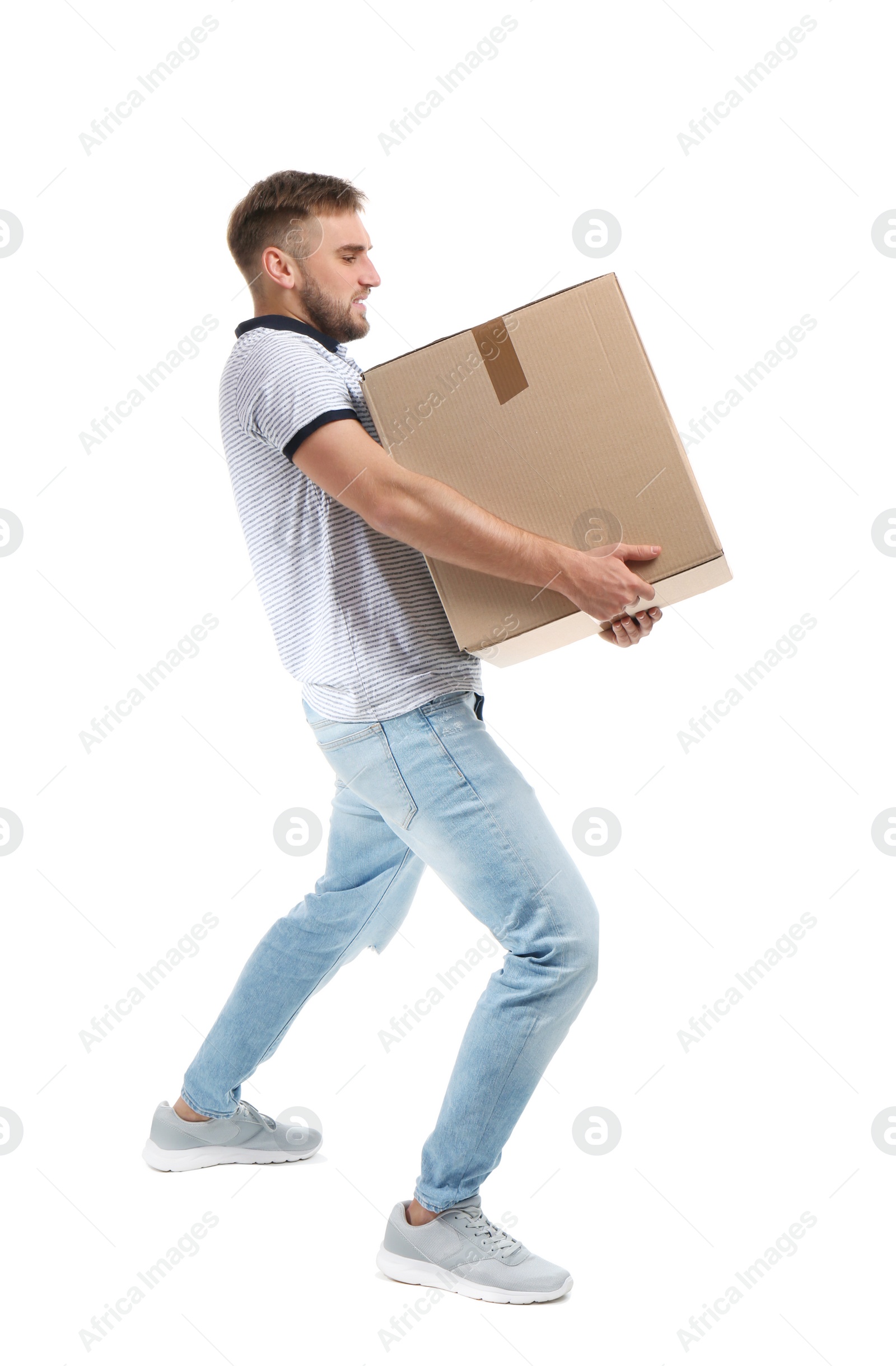 Photo of Full length portrait of young man carrying carton box on white background. Posture concept