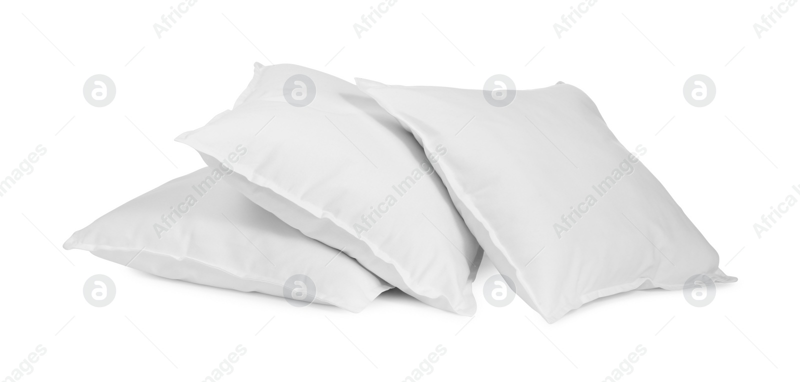 Photo of Three new soft pillows isolated on white