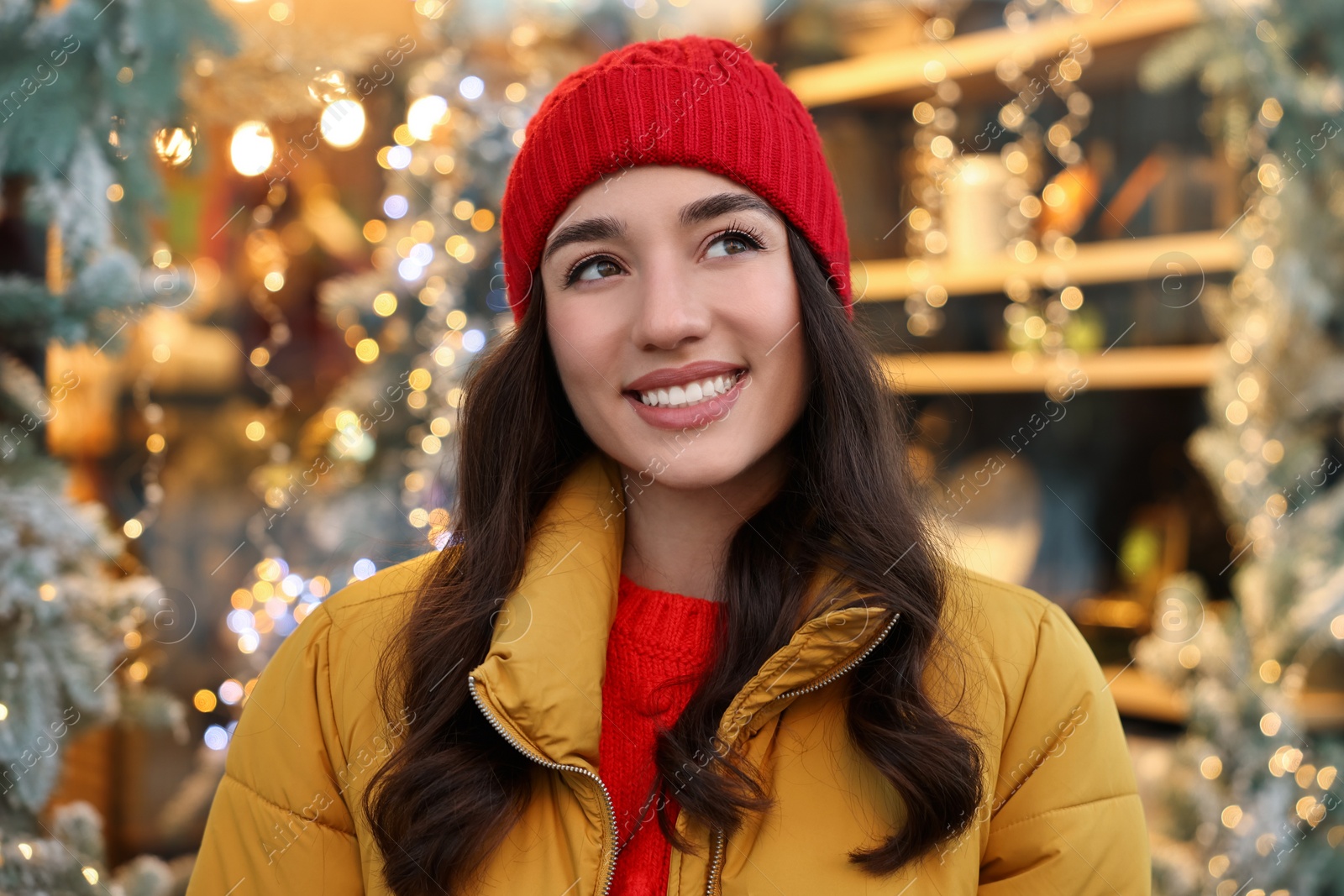 Photo of Portrait of smiling woman on blurred background. Winter time