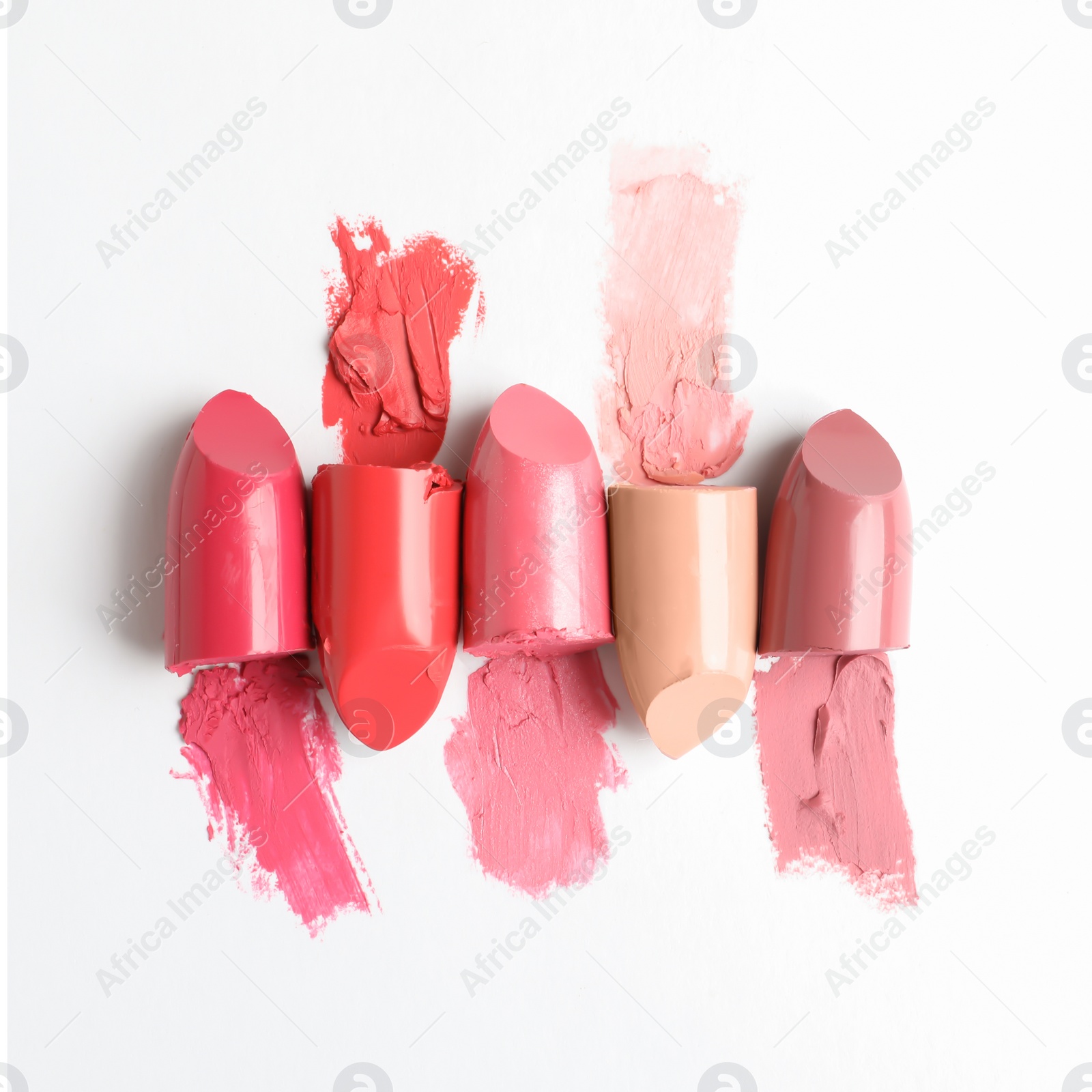 Photo of Different lipstick swatches on white background, top view