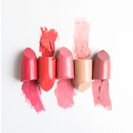 Different lipstick swatches on white background, top view