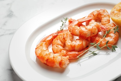 Photo of Plate with delicious fried shrimps on light background, closeup