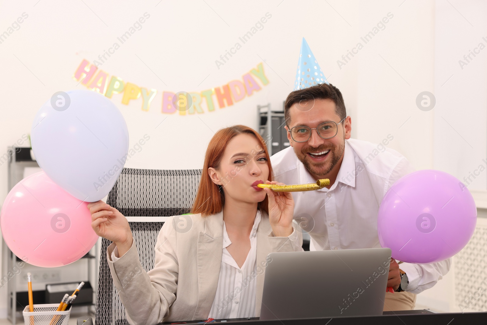 Photo of Coworkers having fun during office party indoors