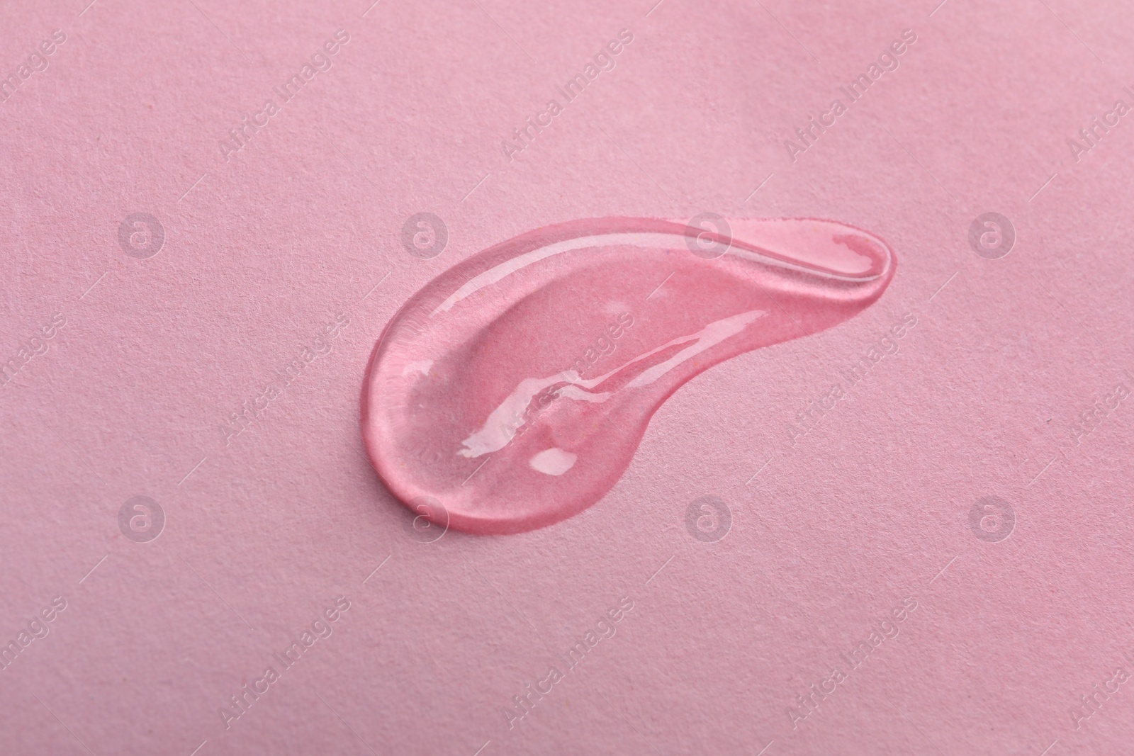 Photo of Swatch of cosmetic gel on pink background, top view