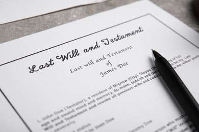 Photo of Last will and testament on light grey table, closeup