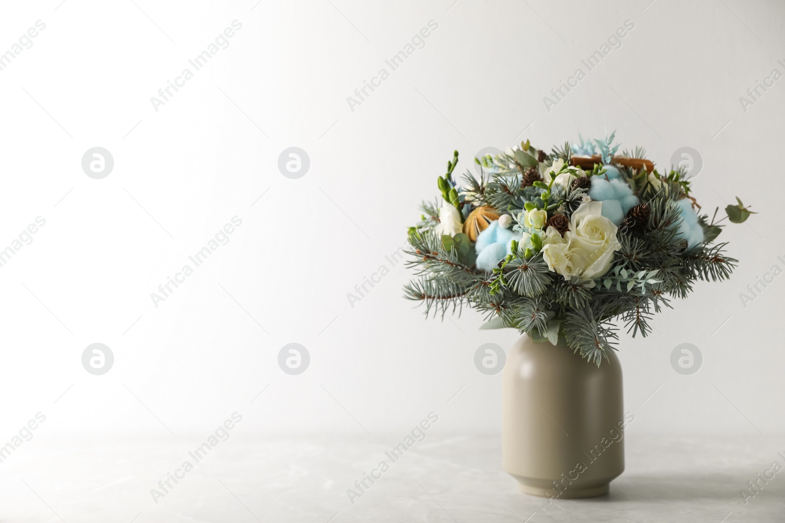 Photo of Beautiful wedding winter bouquet on grey table. Space for text