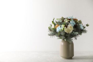 Beautiful wedding winter bouquet on grey table. Space for text