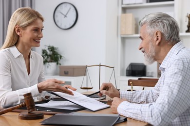 Photo of Senior man having meeting with lawyer in office