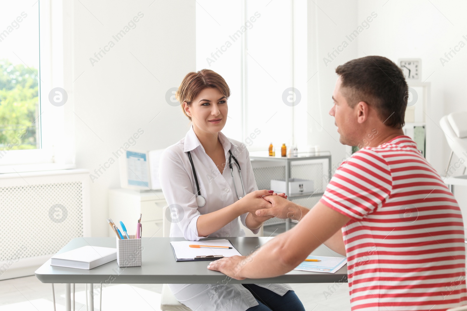 Photo of Patient having appointment with doctor in hospital