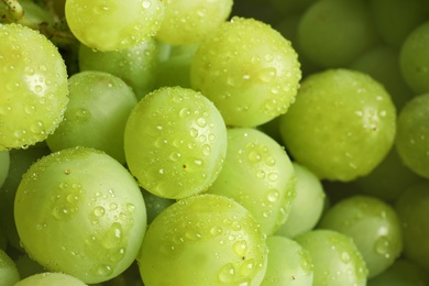 Photo of Bunch of green fresh ripe juicy grapes as background, closeup