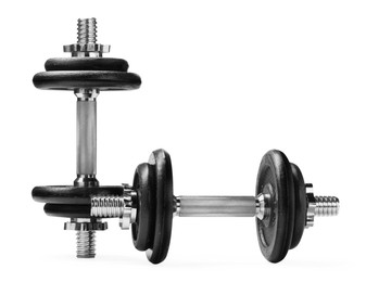 Photo of Metal dumbbells isolated on white. Sports equipment