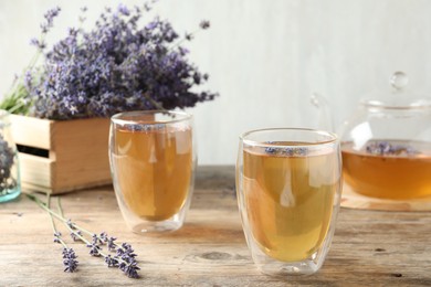 Fresh delicious tea with lavender in glass on wooden table