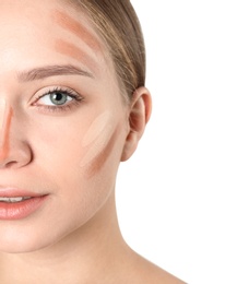 Photo of Portrait of beautiful young woman with makeup contouring smears on face against white background