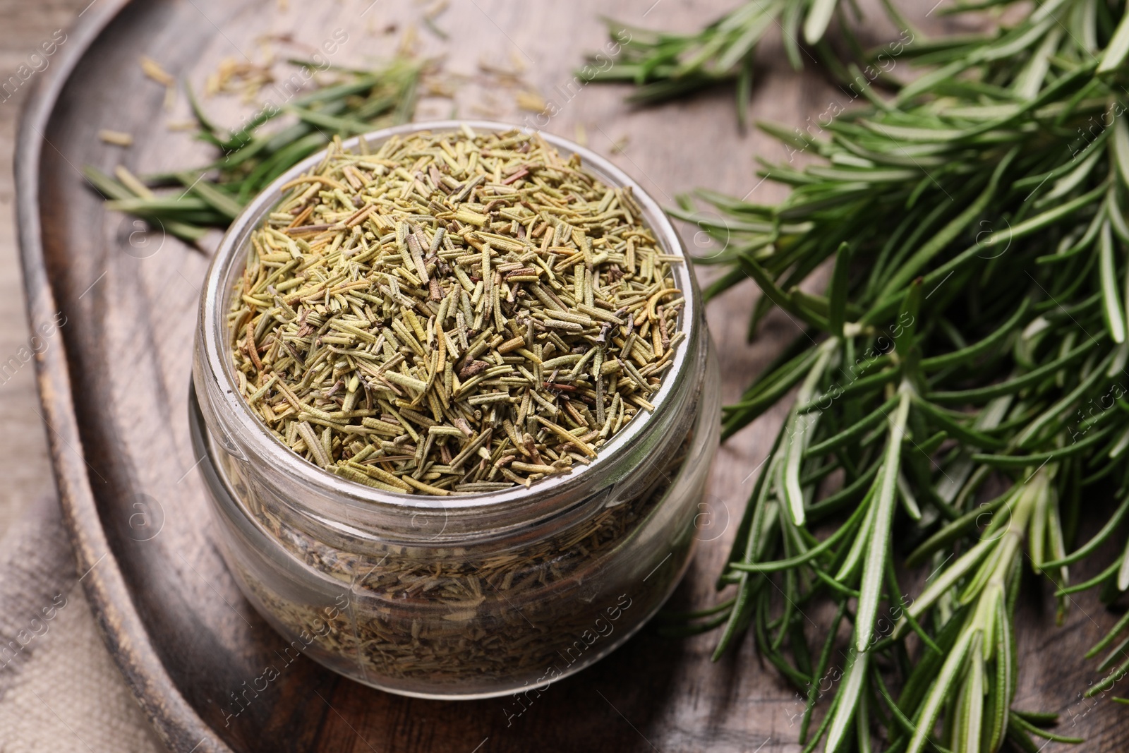 Photo of Dry and fresh rosemary on board, closeup