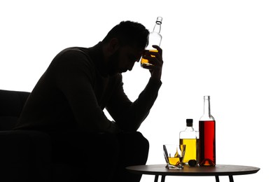 Photo of Silhouette of addicted man with alcoholic drinks on white background