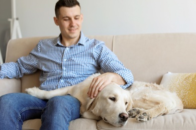 Portrait of owner with his friendly dog at home