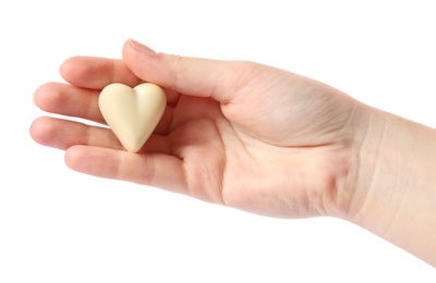 Photo of Woman holding heart shaped chocolate candy on white background, closeup