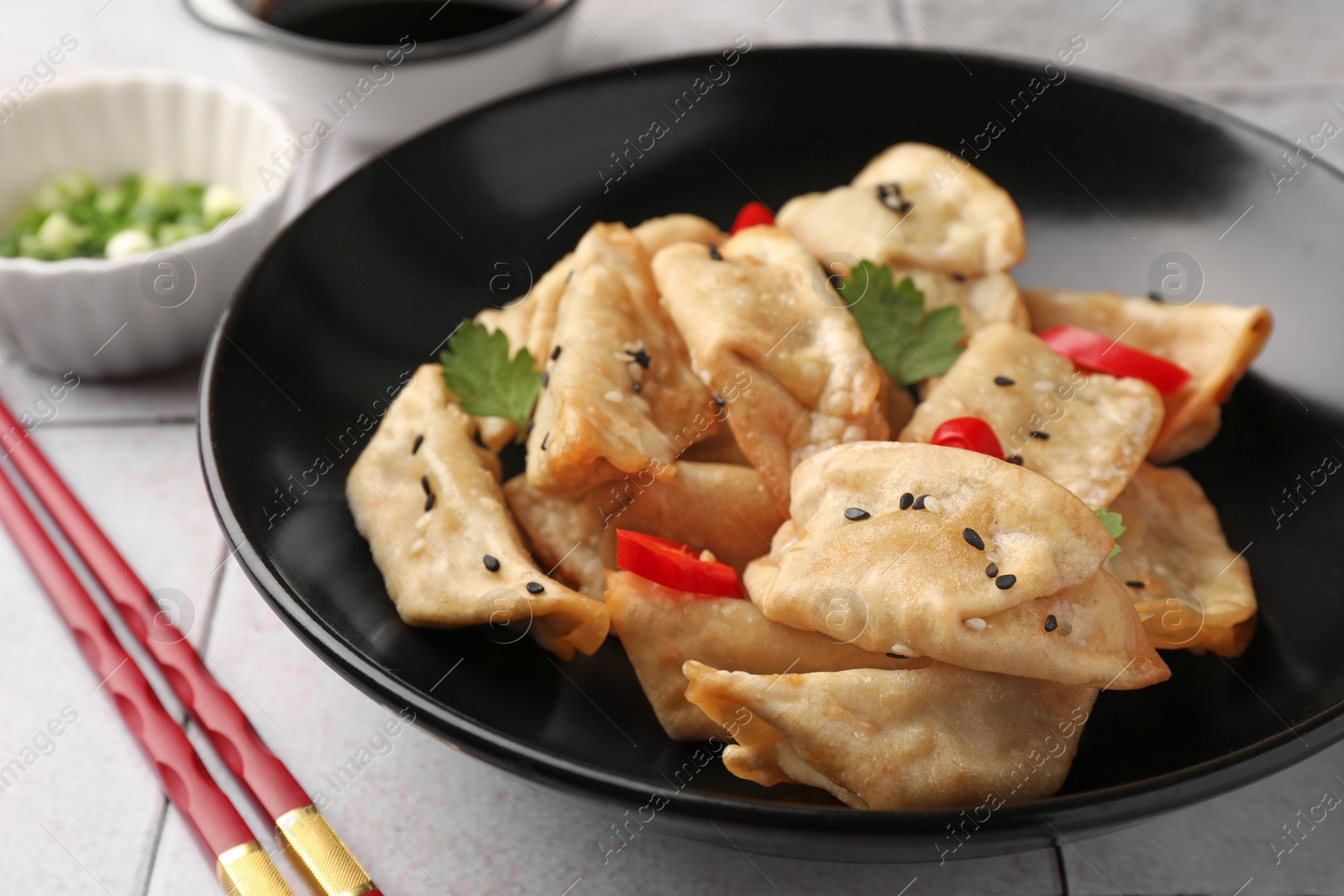 Photo of Delicious gyoza (asian dumplings) in bowl on table