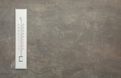 Photo of Weather thermometer on grey background, top view. Space for text