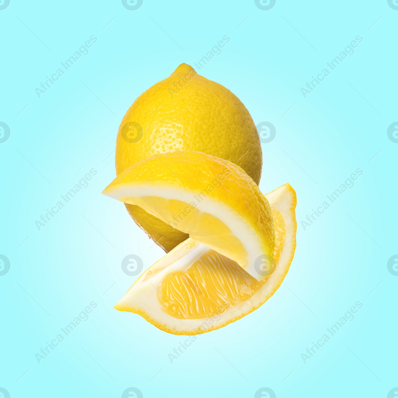 Image of Fresh lemons falling on light blue background