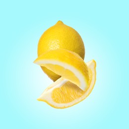 Fresh lemons falling on light blue background