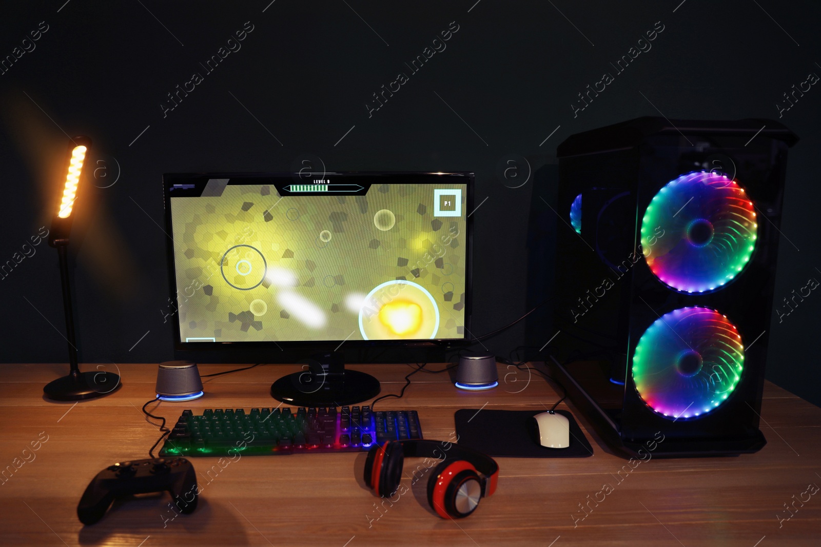 Photo of Modern computer and RGB keyboard on wooden table in room