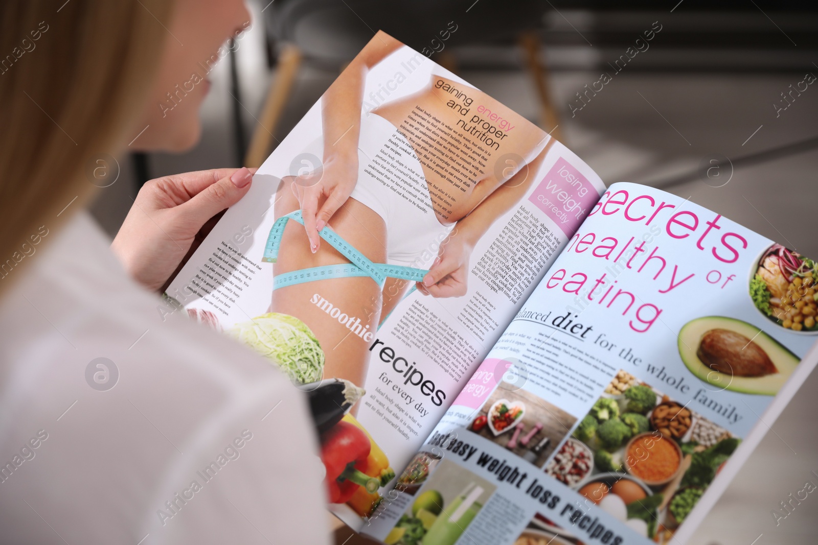 Photo of Woman reading interesting magazine in office, closeup