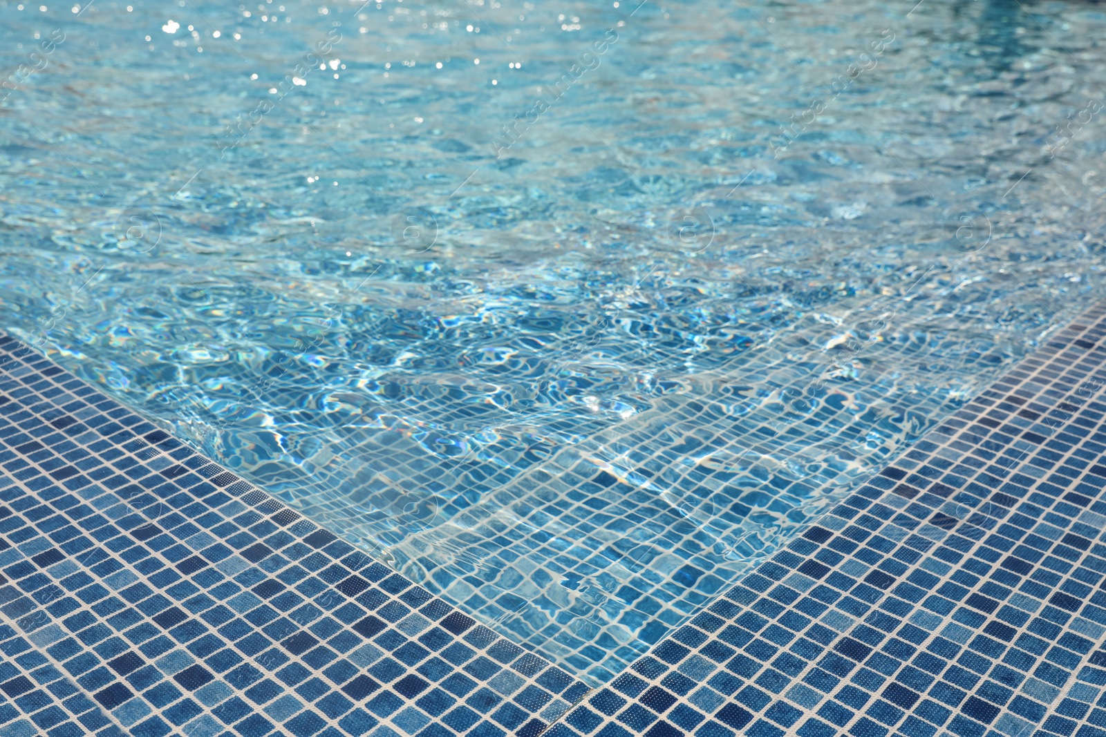 Photo of Swimming pool with clean blue water. Summer vacation