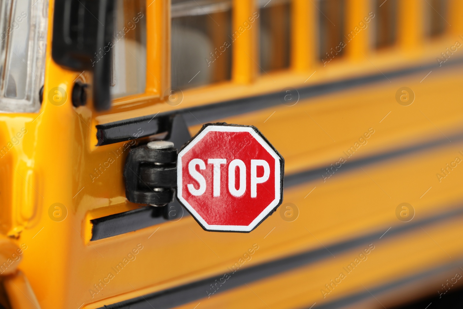 Photo of Yellow school bus, focus on stop sign. Transport for students