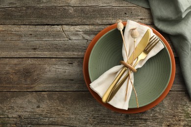 Photo of Stylish setting with cutlery, bowl and plate on wooden table, top view. Space for text