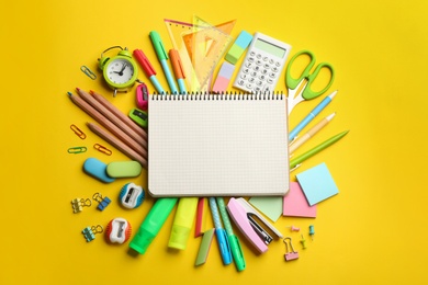 Blank notebook and school stationery on yellow background, flat lay with space for text. Back to school