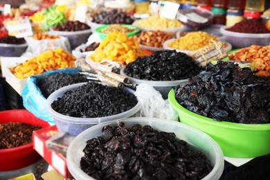 Assortment of different delicious dried fruits on counter at wholesale market