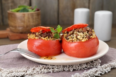 Photo of Delicious stuffed tomatoes with minced beef, bulgur and mushrooms served on table, closeup